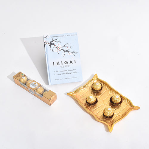 Golden Platter shaped like Alladin's Magic Carpet with a Ferrero Rocher and a book