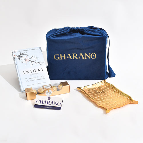 Golden Platter shaped like Alladin's Magic Carpet with a Ferrero Rocher and a book