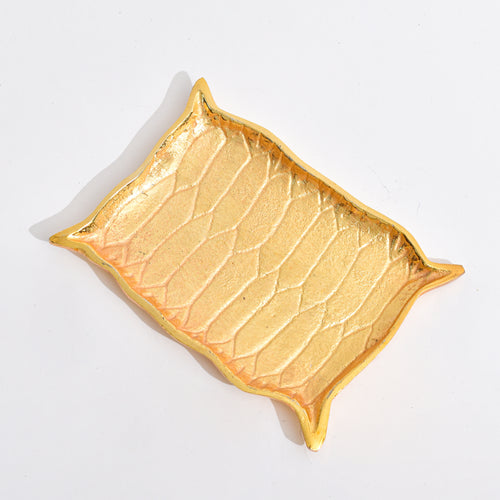 Golden Platter shaped like Alladin's Magic Carpet with a Ferrero Rocher and a book