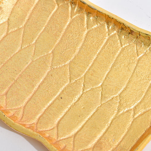 Golden Platter shaped like Alladin's Magic Carpet with a Ferrero Rocher and a book