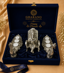 A Gharano Diwali gift set in an open navy velvet box with gold branding featuring a central silver Ganesha figurine and two german silver candle holders with T-lights.