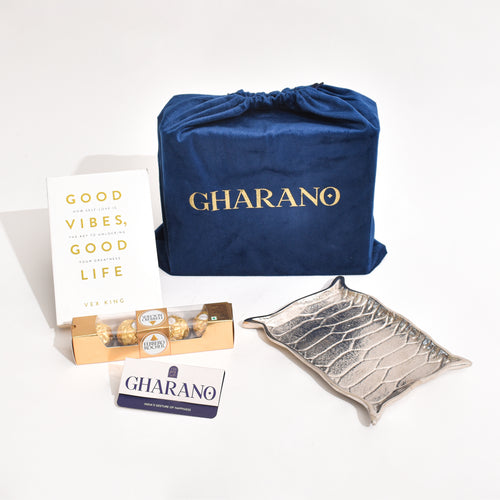 Silver Platter shaped like Alladin's Magic Carpet with a Ferrero Rocher and a book