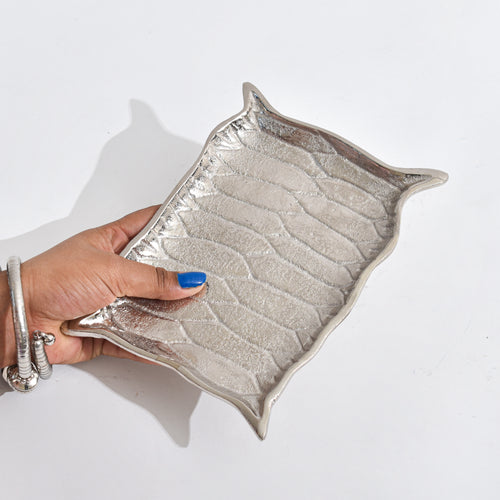 Silver Platter shaped like Alladin's Magic Carpet with a Ferrero Rocher and a book