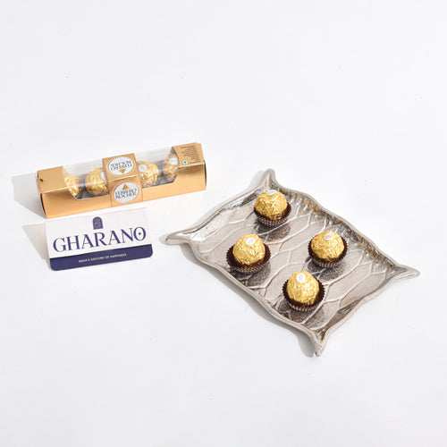 Silver Platter shaped like Alladin's Magic Carpet with a Ferrero Rocher and a book