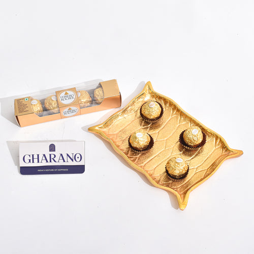 Golden Platter shaped like Alladin's Magic Carpet with a Ferrero Rocher and a book